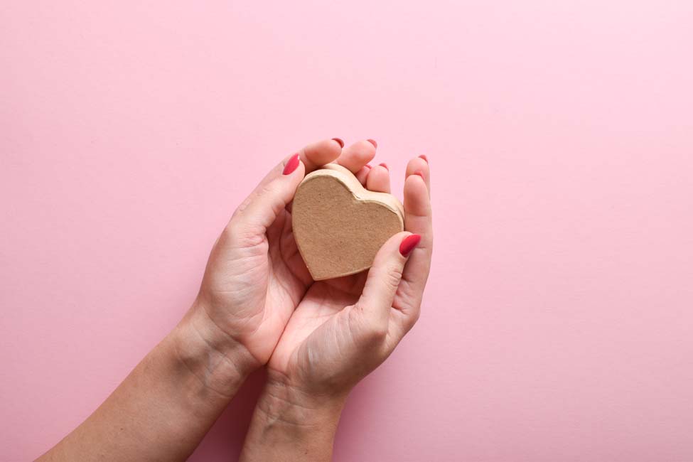 Eco box in the shape of a heart in the hands of a girl